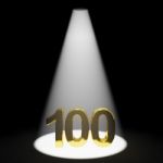 Golden Number 100 With Spotlit Stock Photo