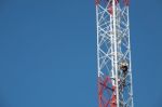 Man On telecommunication Tower Stock Photo