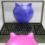 Piggy On Screen Shows Internet Investment Savings Stock Photo