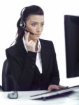 Busy Woman Seriously Hearing The Customer Talk In Headset Stock Photo