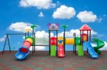 Closeup Colorful Playground With Prevent Injuries Yard In Park On Blue Sky Background Stock Photo