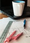 Cup Of Coffee On Laptop With Construction Plans Stock Photo
