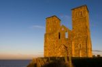 Remains Of Reculver Church Towers Bathed In Late Afternoon Sunsh Stock Photo