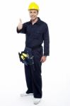 Young Worker Gesturing Thumbs Up Stock Photo