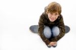 High Angle View Of Boy Sitting On Skateboard Stock Photo