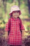 Cute Little Asian Girl Looking At Camera And Smiling Over Nature Stock Photo