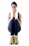 Squatting Female Athlete Stock Photo