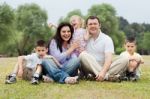Portrait Of Happy Family Of Five On The Green Land Stock Photo