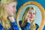 Blonde Girl Looking In Mirror Stock Photo