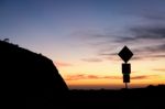 Road Sign Silhouette And Colorful Sunset Stock Photo