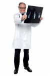 Senior Medical Practitioner Reviewing X-ray Sheet Stock Photo