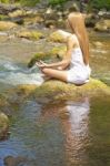 Beautiful Woman Practive Yoga On River In Nature Stock Photo