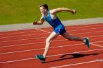 Young Caucasian Athlete Sprinting On Track Stock Photo