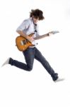 Jumping Young Male With Guitar Stock Photo