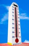 Tower Of Thermometer Isolated On Blue Sky Background Stock Photo