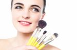 Portrait Of A Beautiful Girl With Makeup Brushes Stock Photo