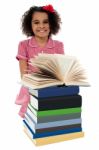 Portrait Of Pretty Schoolgirl Reading Textbook Stock Photo