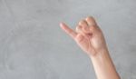 Hand Action Gesture On Grey Background Stock Photo