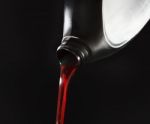 File Close Up Red Motor Oil Pouping From Black Plastic Bottle Ag Stock Photo