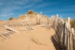 Three Rows Of Broken Fence On Sand Dunes Horizontal Wide Stock Photo
