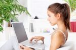 Woman Working On Laptop At Home Stock Photo
