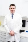 Smiling Male Doctor Posing In Lab Coat Stock Photo