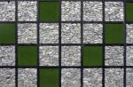 Artificial Grass And Stone Pattern Wall Stock Photo