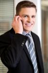 Smiling Corporate Guy Attending Phone Call Stock Photo