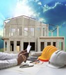 Home Construction And Hand Hold Tablet On Engineer Working Table Use For Real Estate And Construction Business Stock Photo
