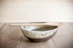 Bowl On Wooden Table Over Grunge Background Stock Photo
