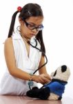 Girl Playing At Being A Doctor Stock Photo