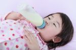 Closeup Cute Asian Girl Suck Up Milk Bottle. Drinking Milk For Good Health Stock Photo