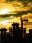 Silhouette Of Crane And Building Construction And Sun Set Sky Wi Stock Photo