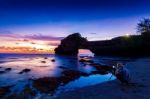 Professional Photographer With Camera And Tripod In Tanah Lot Temple At Sunset, Bali In Indonesia.(dark)seascape Stock Photo