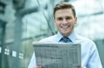 Handsome Businessman Reading A Newspaper Stock Photo