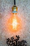 Vintage Hanging Light Bulb Decorated On Brown Wall Stock Photo