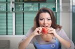 Asian Woman Is Eating An Apple Stock Photo