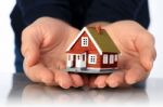 Hands And Small House Stock Photo