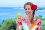 Dutch Woman With Drink And Red Rose Near Sea Stock Photo