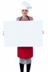 Young Baker Woman Holding A Blank Whiteboard Stock Photo