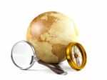 Globe With Magnifying Glass And Compass Stock Photo