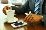 Man Using Mobile Phone In The Coffee Shop Stock Photo
