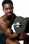 African Guy Lifting Dumbbells Stock Photo