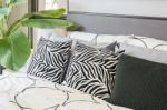 Black And White Pillows And Blanket On Modern Bed Stock Photo