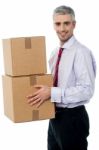 Young Corporate Man Holding Card Box Stock Photo
