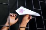 Hand In Jail Showing Colorful Paper Airplane Stock Photo