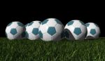 Cyan Soccer Balls On A Green Grass Stock Photo