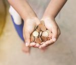 Hand Of Child With Coins Stock Photo
