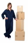 Beautiful Delivery Woman Standing Beside Cartons Stock Photo