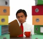 Businessman With Stacked Files Stock Photo